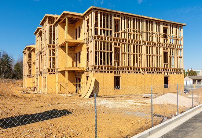 a job site enclosed by temporary chain link fences, ensuring safety for workers and pedestrians in Gilbert